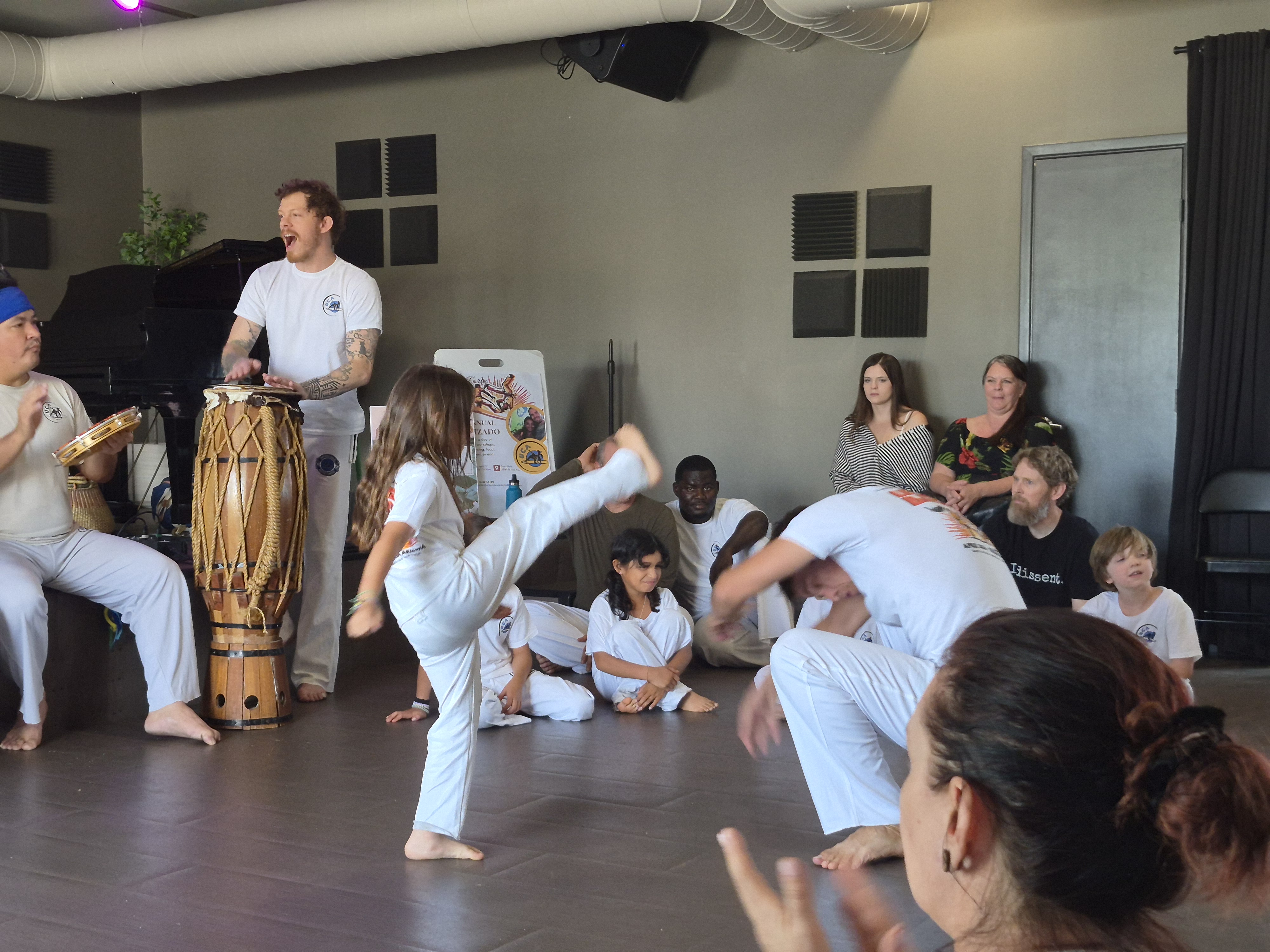 Girl throwing a kick at instructor
